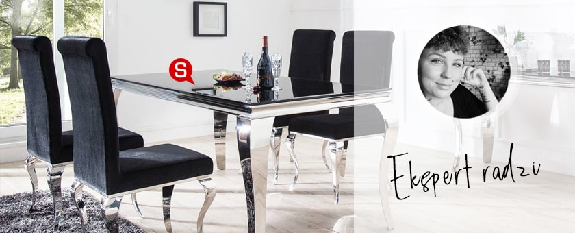 Jadalnia glamour z białymi ścianami oraz eleganckim stołem, na którym znajdują się kieliszki. Przy stole znajdują się eleganckie krzesła tapicerowane.